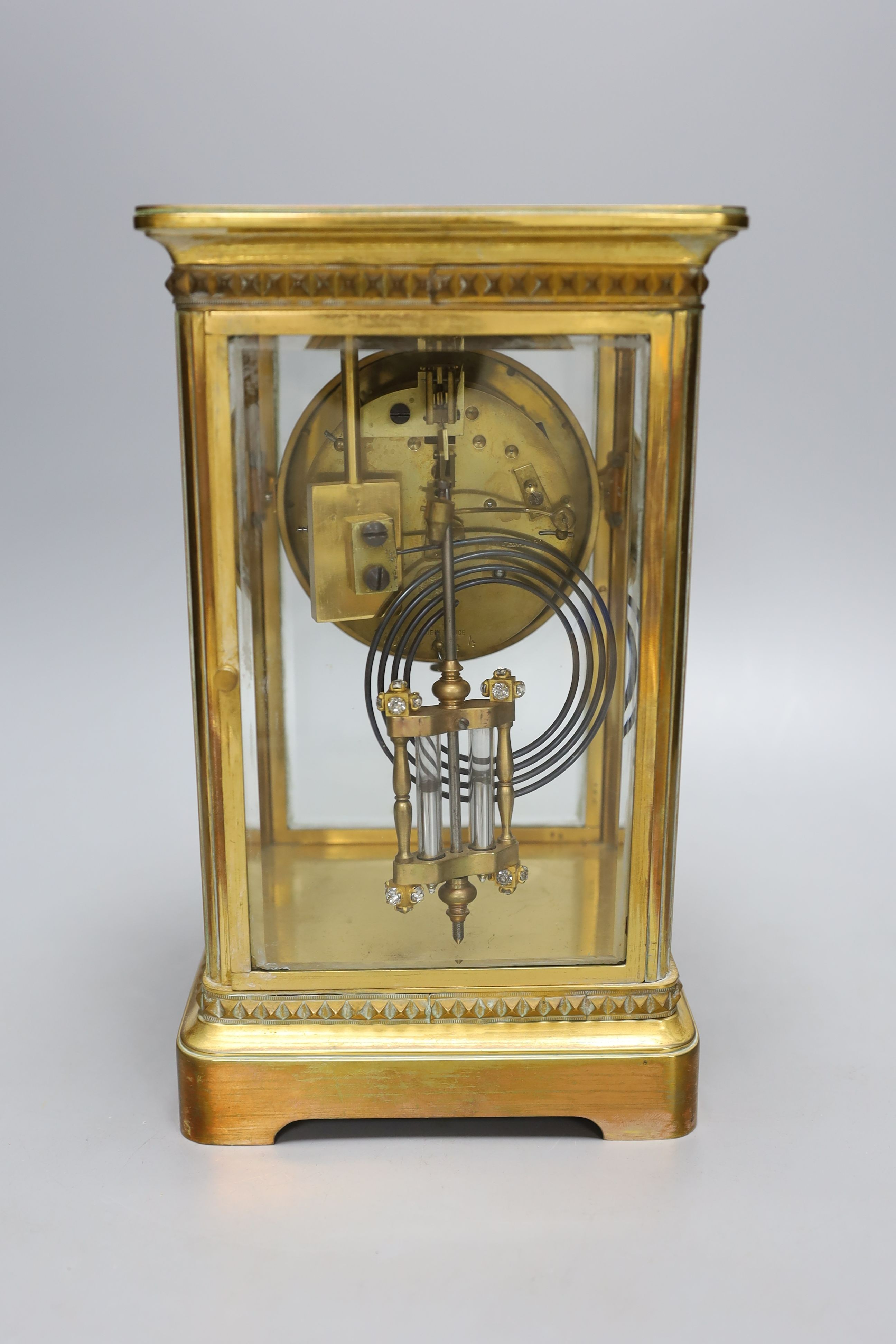 An early 20th century paste set brass four glass mantel clock retailed by Tiffany & Co. Includes paste set mercury pendulum. No key. Height - 26cm